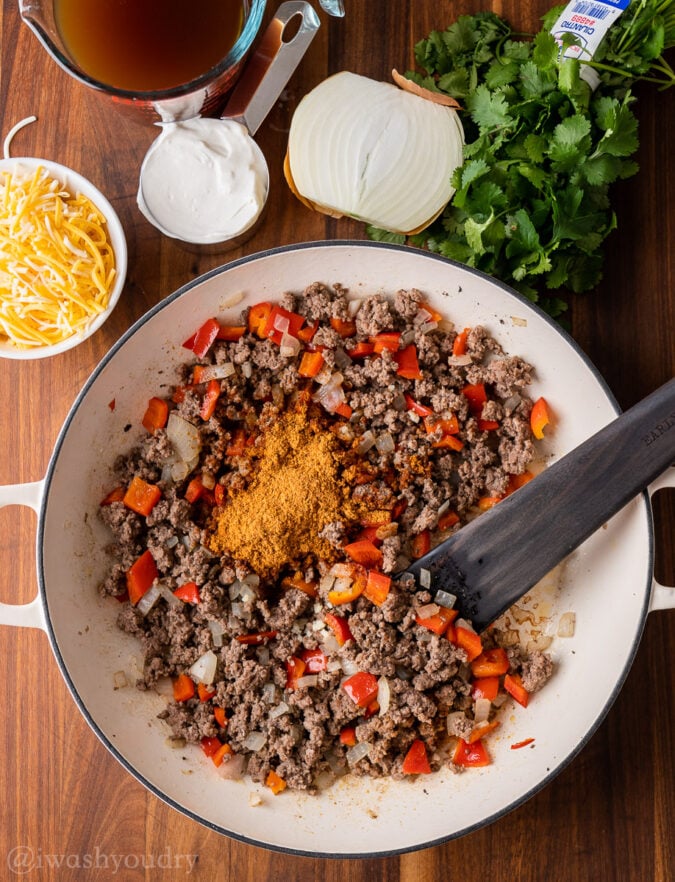 ground beef and peppers in pan with seasoning