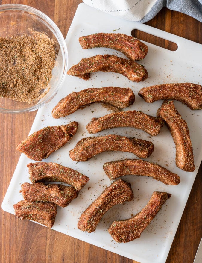 ribs coated with spices on cutting board