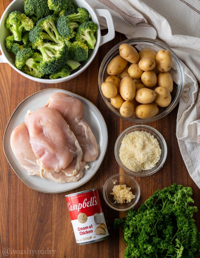 ingredients needed for creamy chicken on wooden surface