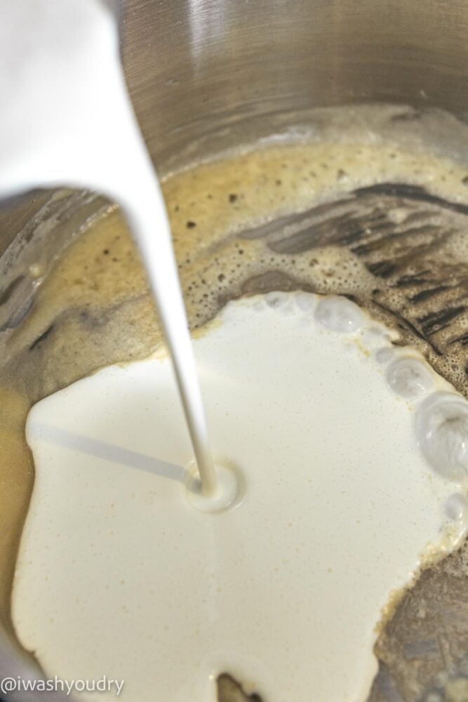 pouring heavy cream into pan