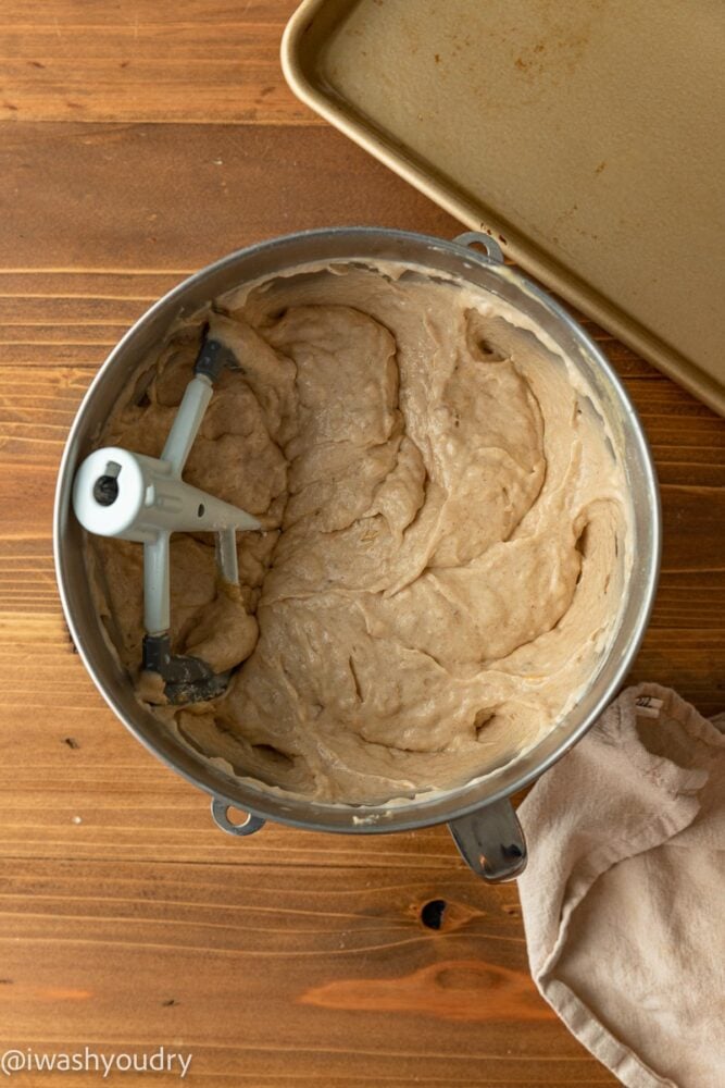 bowl of banana cake batter with mixer paddle.