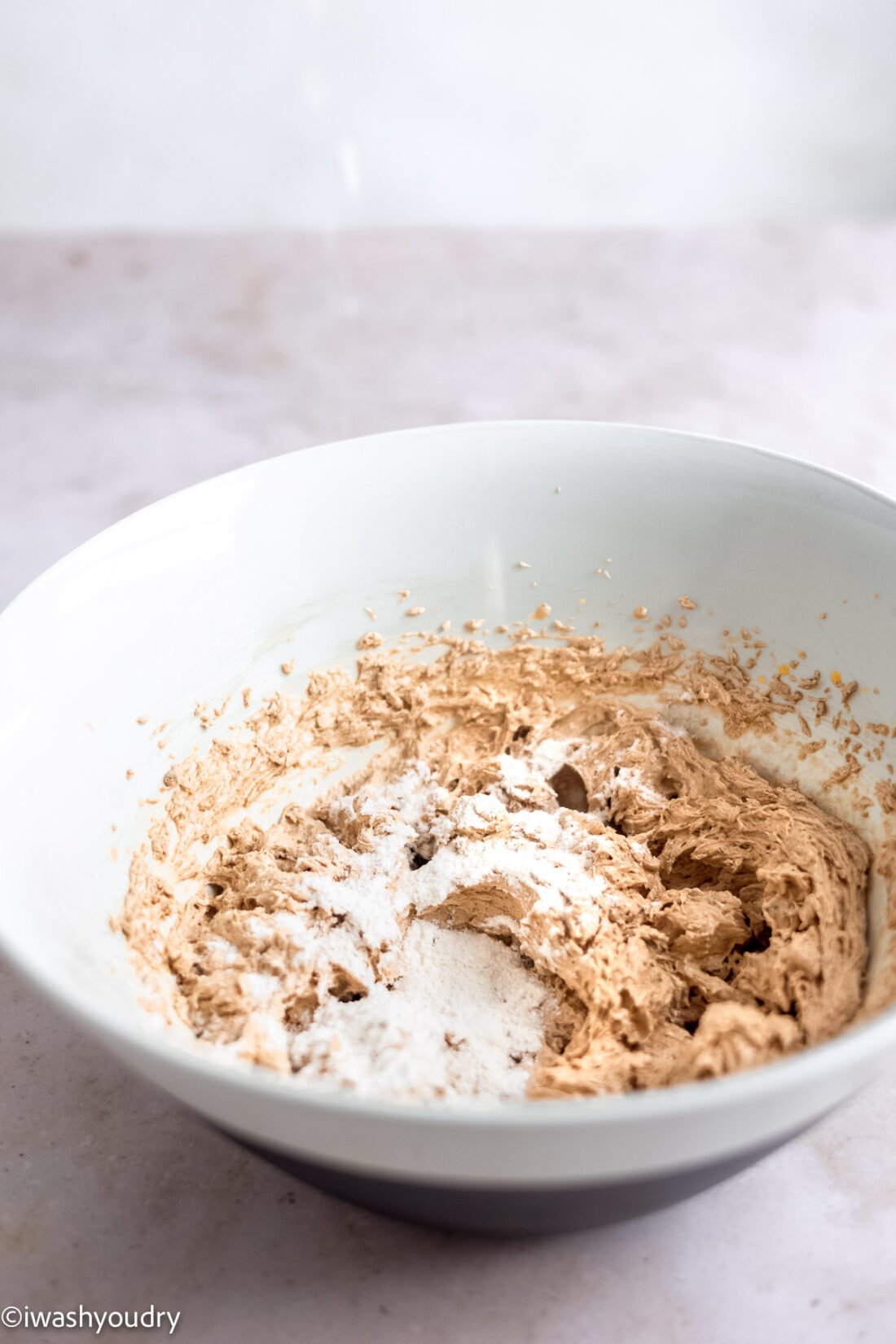 Flour in bowl of creamed butter and sugar. 