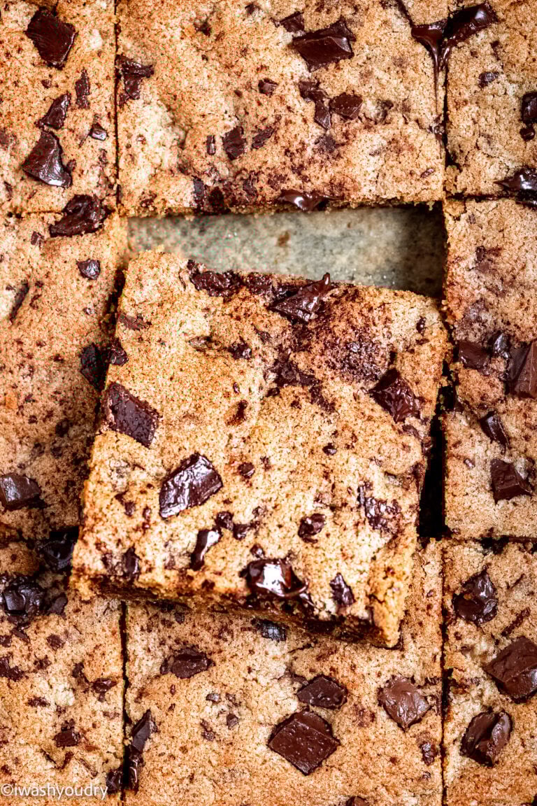 Slice of baked chocolate chip blondie resting on other baked slices.