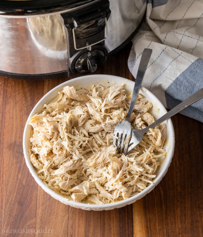 shredded chicken in a bowl with two forks.