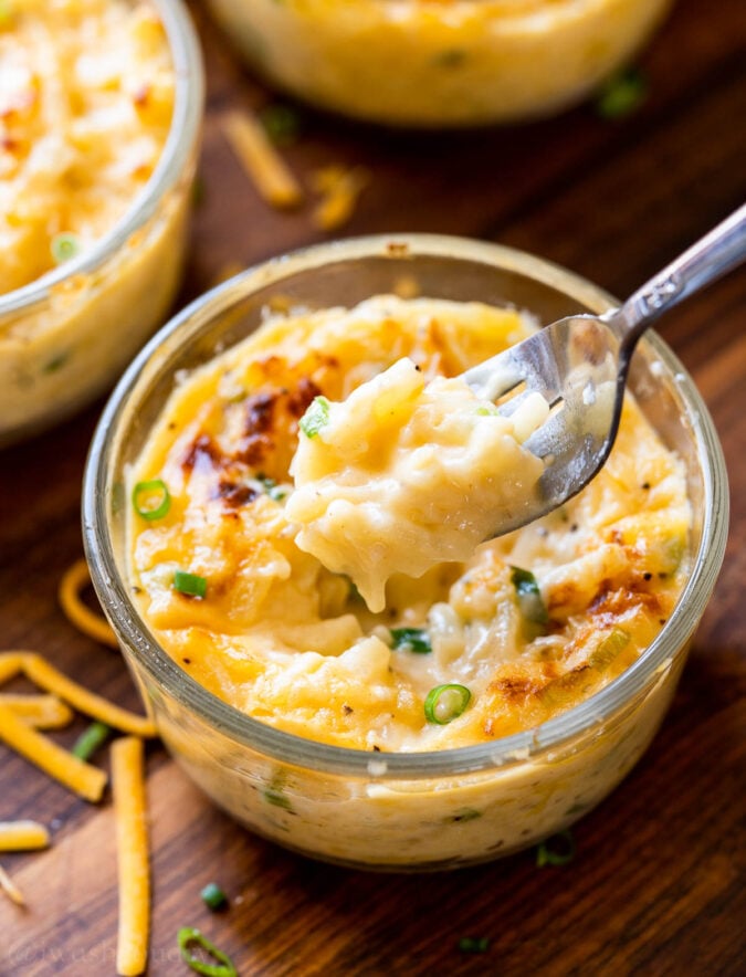 fork full of potatoes with cheese.