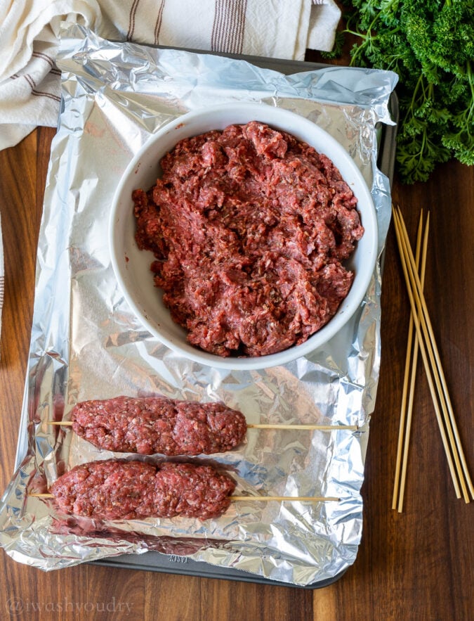 meatloaf on stick with bowl and wooden skewers.
