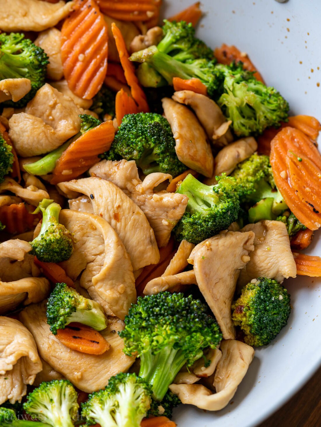 Cooked broccoli chicken stir fry in pan zoomed in. 