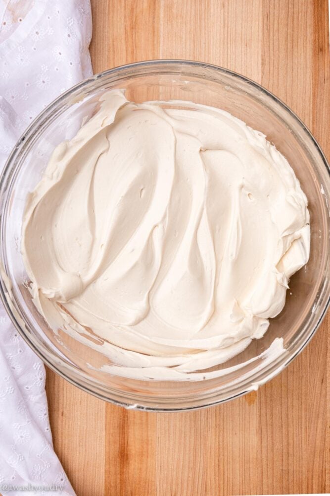 Whipped frosting in bowl with white cloth.