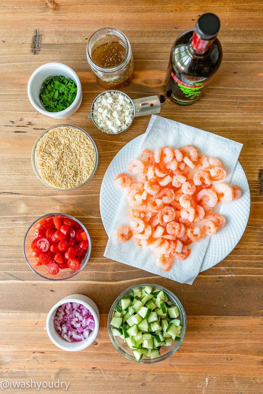 Ingredients for orzo pasta salad with shrimp on wooden table. 