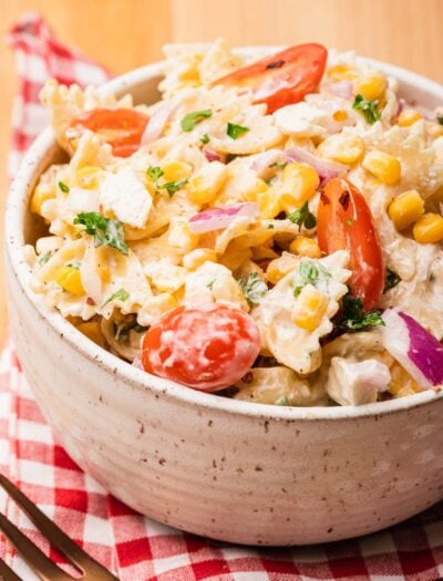bowl of pasta salad with corn on red napkin