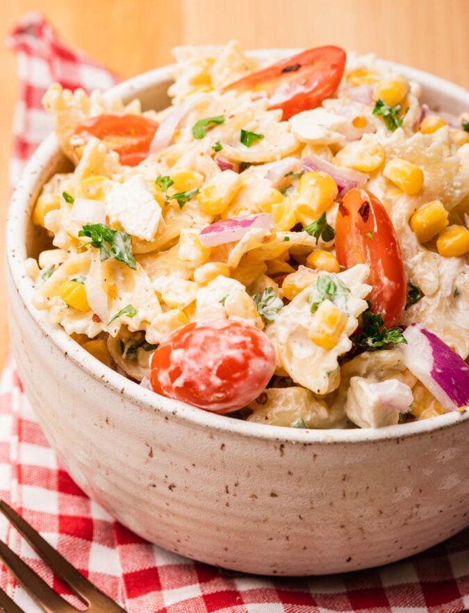bowl of corn pasta salad on a red napkin