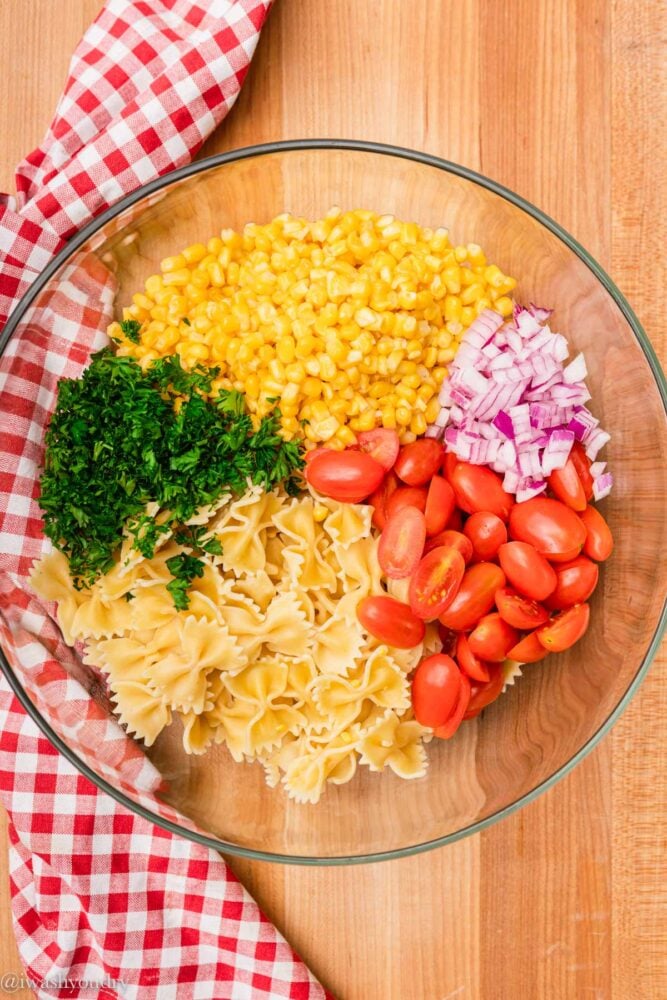 bowl of pasta and corn with tomatoes
