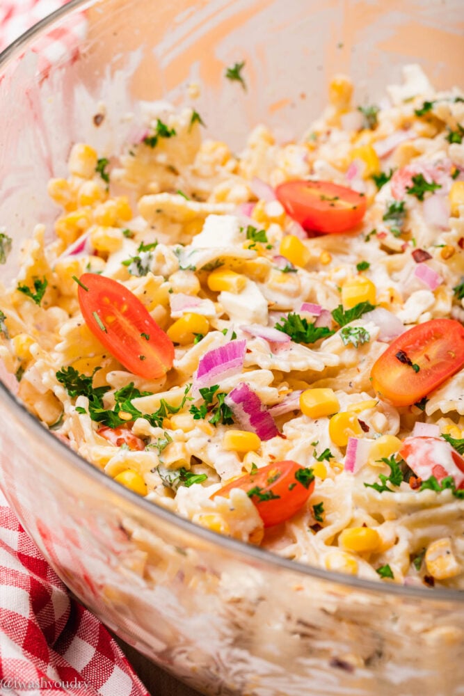 bowl with creamy corn salad and tomatoes