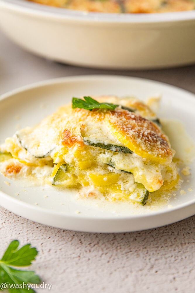 plate of zucchini squash casserole with parsley and parmesan cheese.