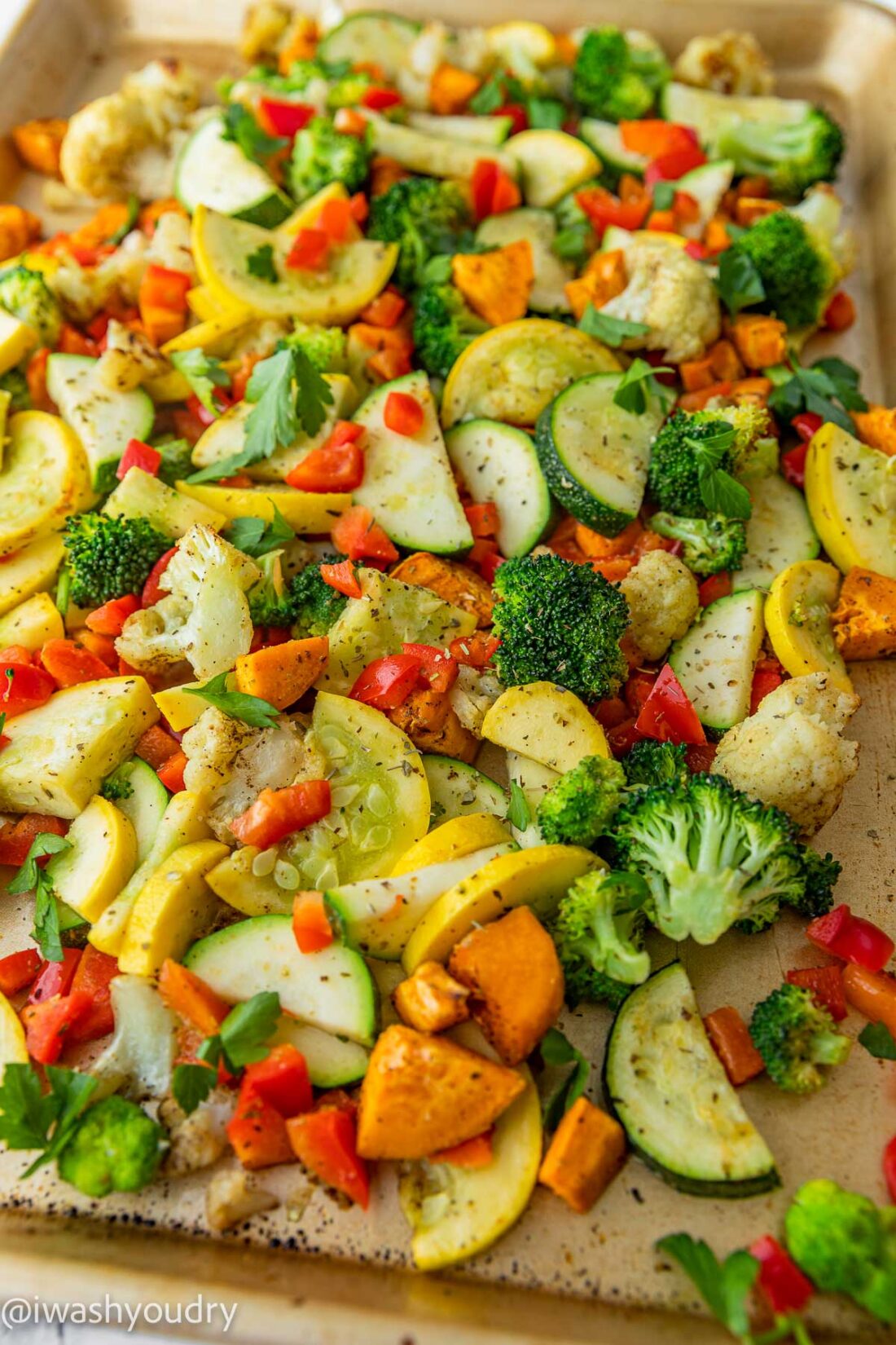 Rainbow roasted vegetables cooked on a metal baking sheet. 