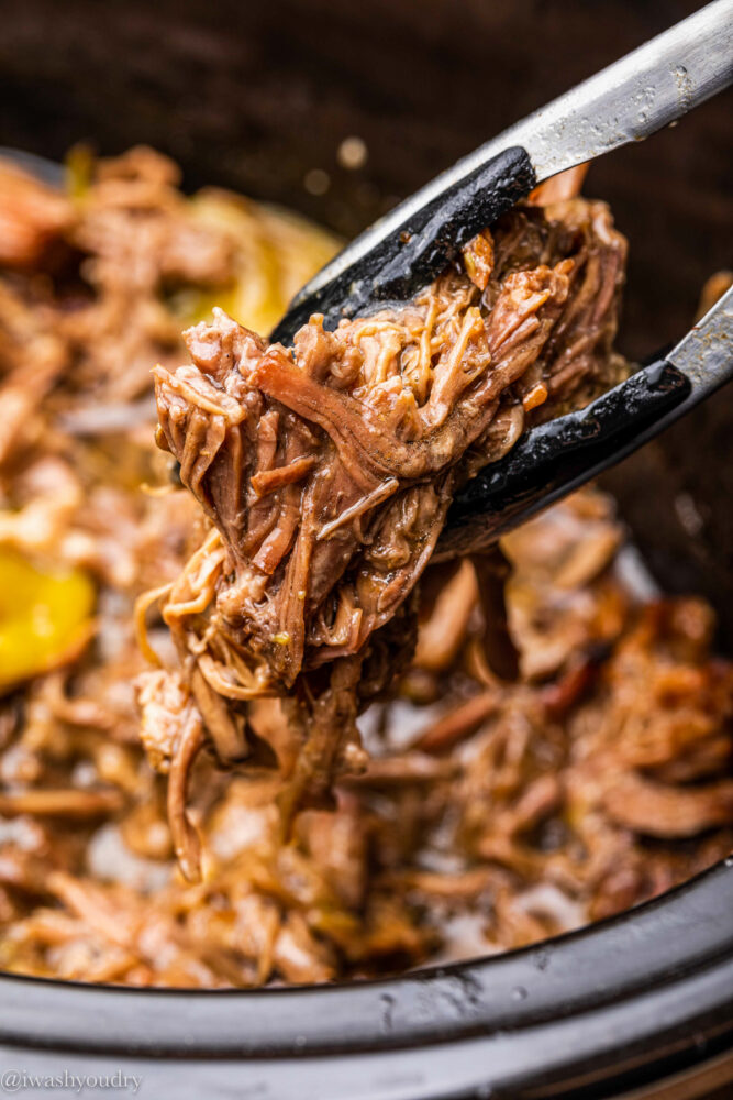 tongs picking up shredded beef