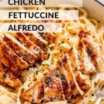 cooked chicken with alfredo sauce and noodles in pan.