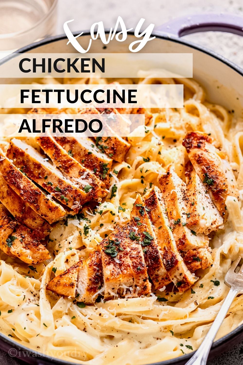 cooked chicken with alfredo sauce and noodles in pan.