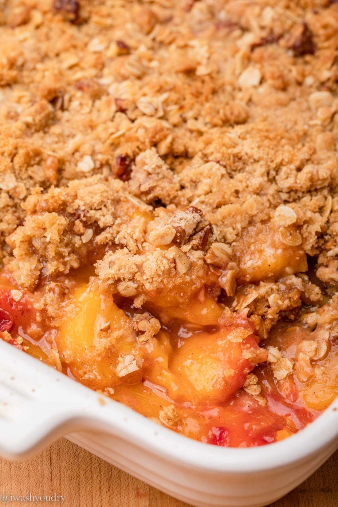 Easy Peach Crisp in a white baking dish.