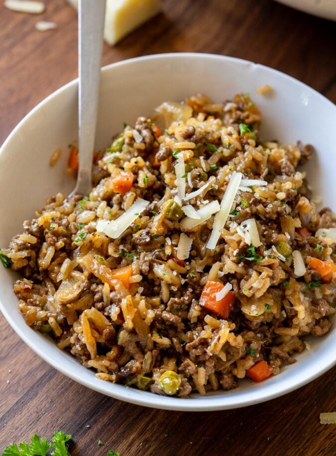 bowl of ground beef rice casserole topped with cheese