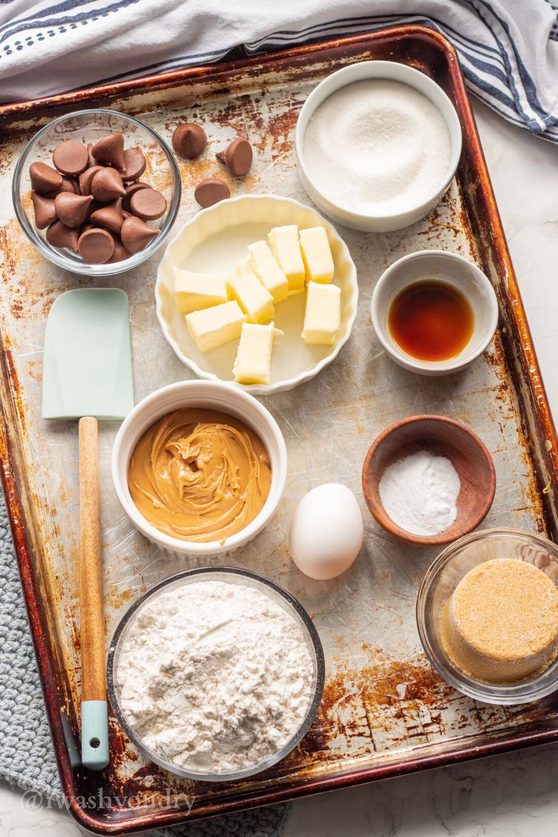 Ingredients for peanut butter Kiss Cookies on baking sheet. 