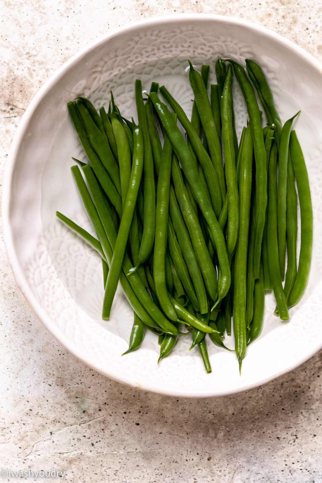 green beans in a bowl of cold water.