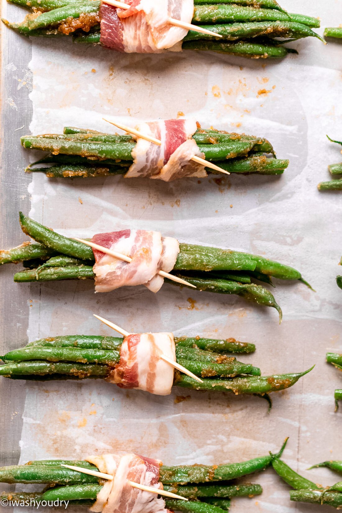 green bean bundles with bacon wrapped around the middle, secured with toothpick.