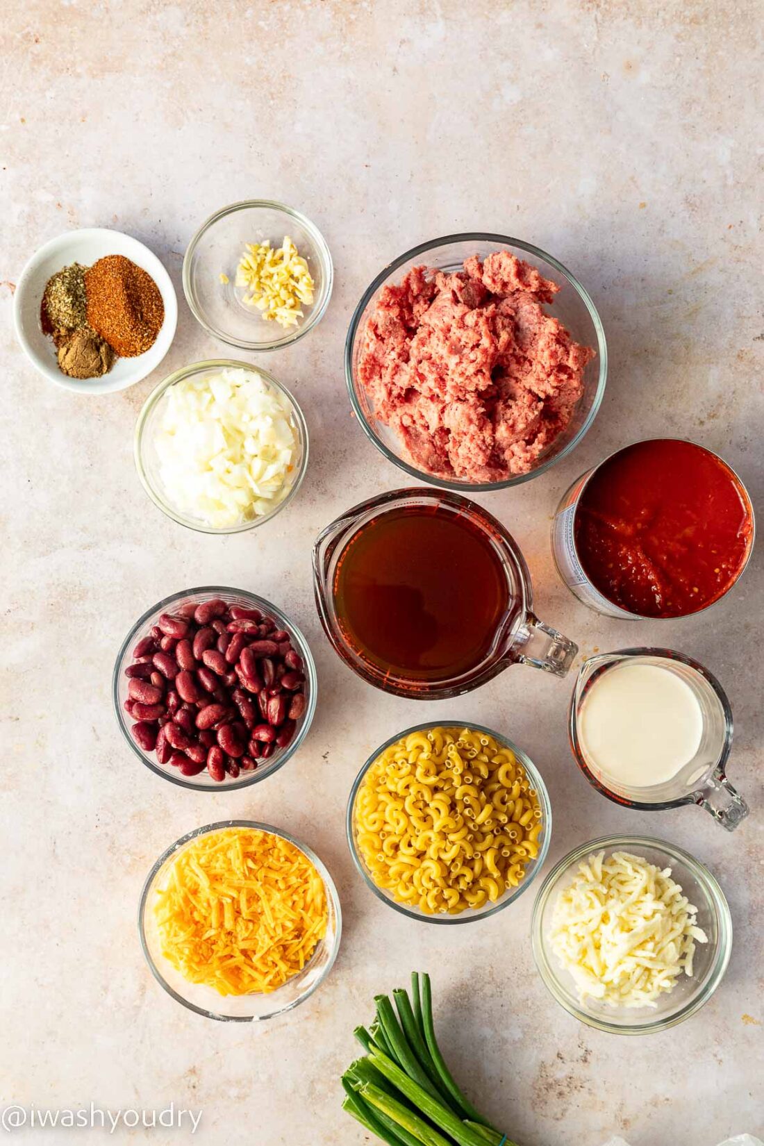 ingredients for chili mac on white surface.