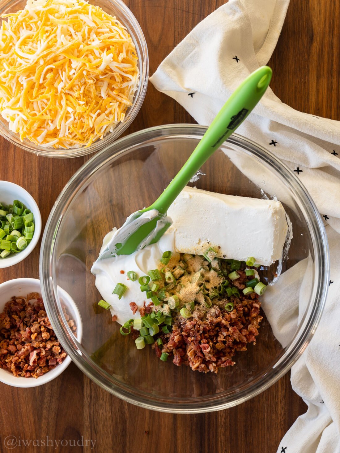 creamy ingredients in glass bowl with green spatula