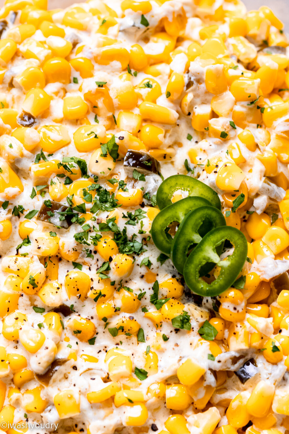 Creamed corn with jalapeno on top. 