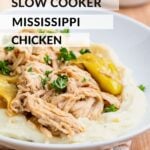 Cooked slow cooker mississippi chicken on white plate.