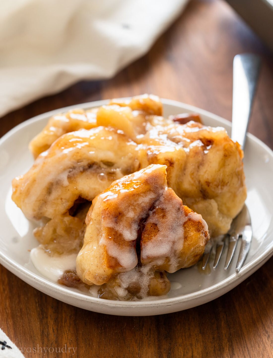 plate full of cinnamon roll and apples.
