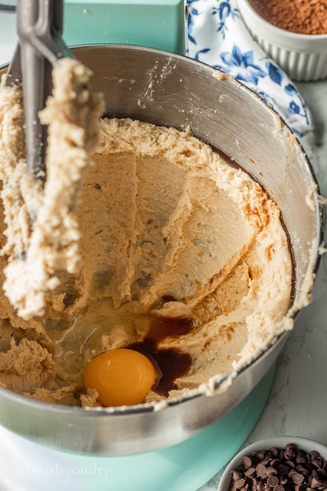 Egg in mixing bowl with butter, brown sugar, and vanilla extract.