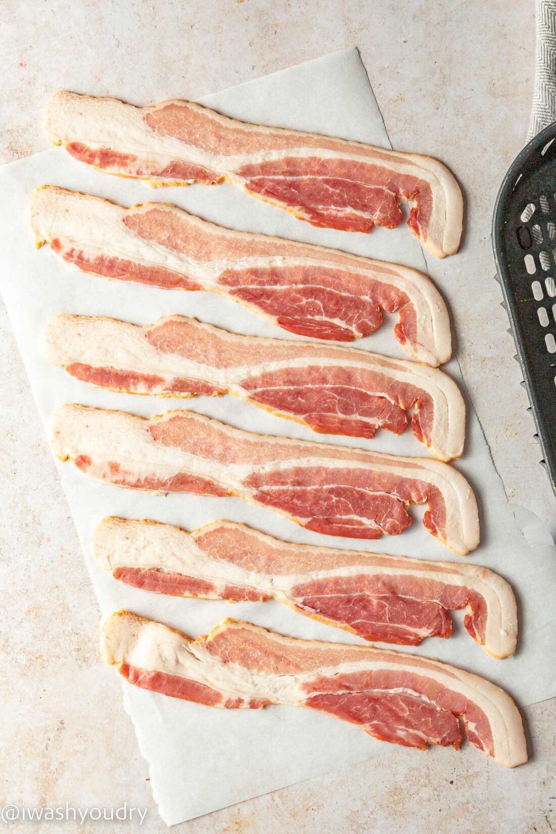 Raw Bacon on parchment paper. 
