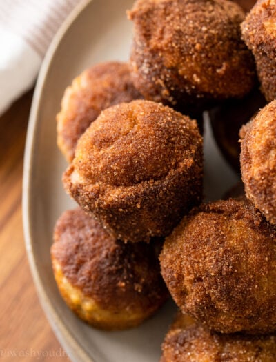 plate full of banana muffins with cinnamon and sugar coating.
