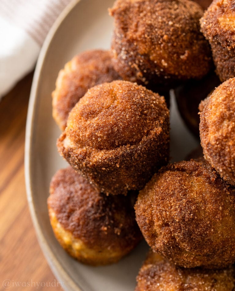 plate full of banana muffins with cinnamon and sugar coating.