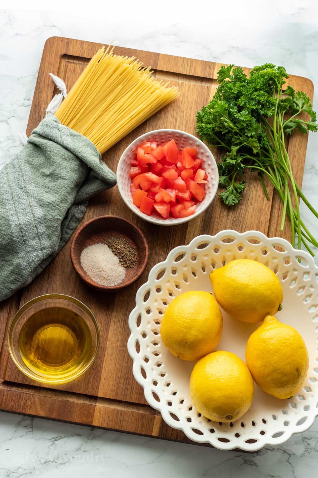 Ingredients for lemon capellini salad on wood cutting board. 