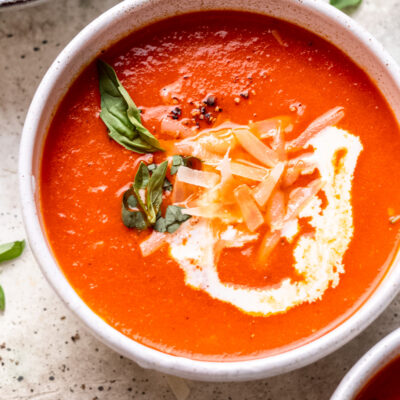 bowl of tomato soup with basil and cream.