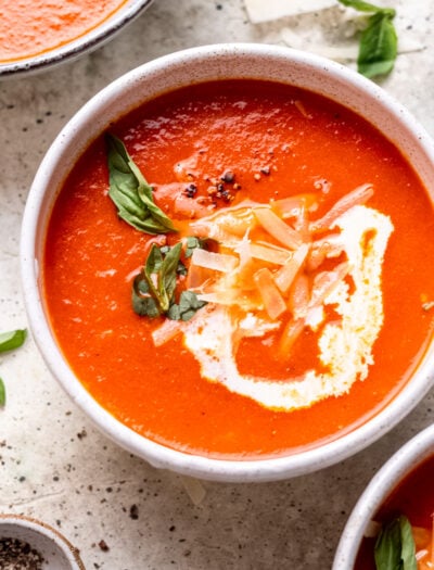 bowl of tomato soup with basil and cream.