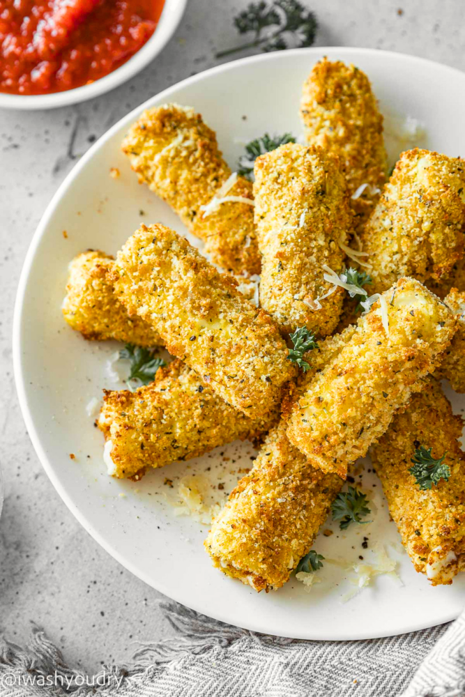 Plate of mozzarella sticks with parsley.