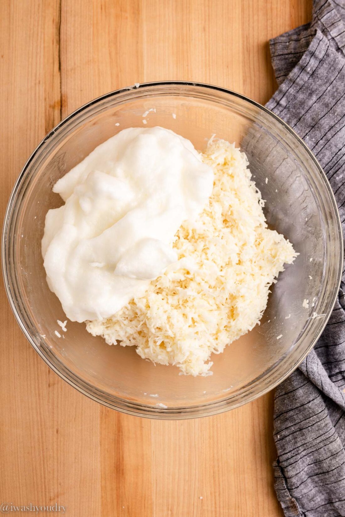 Egg whites and coconut mixture in glass bowl. 