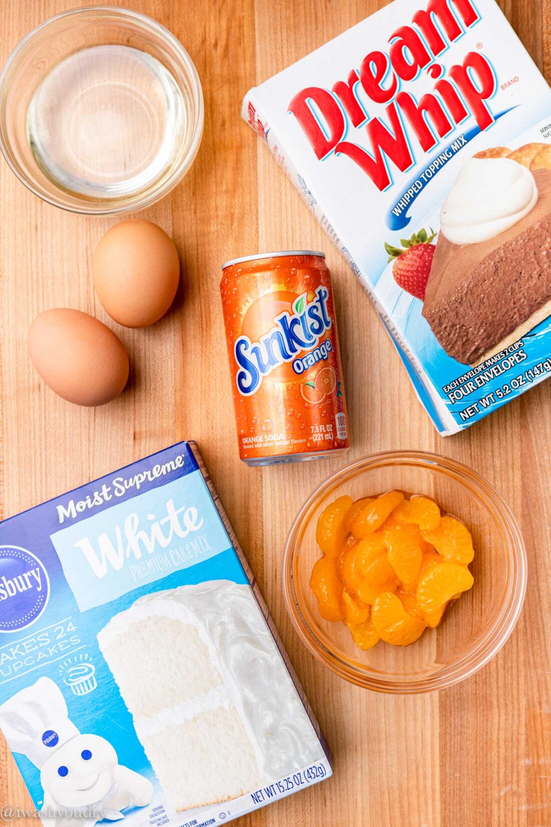 ingredients for orange crush cake including orange soda, cake mix, eggs, Dream Whip, and mandarin oranges