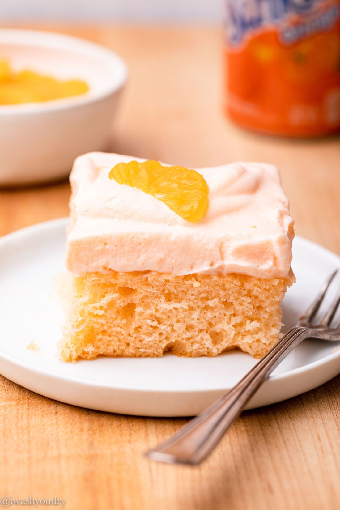 a slice of orange soda cake on plate with fork