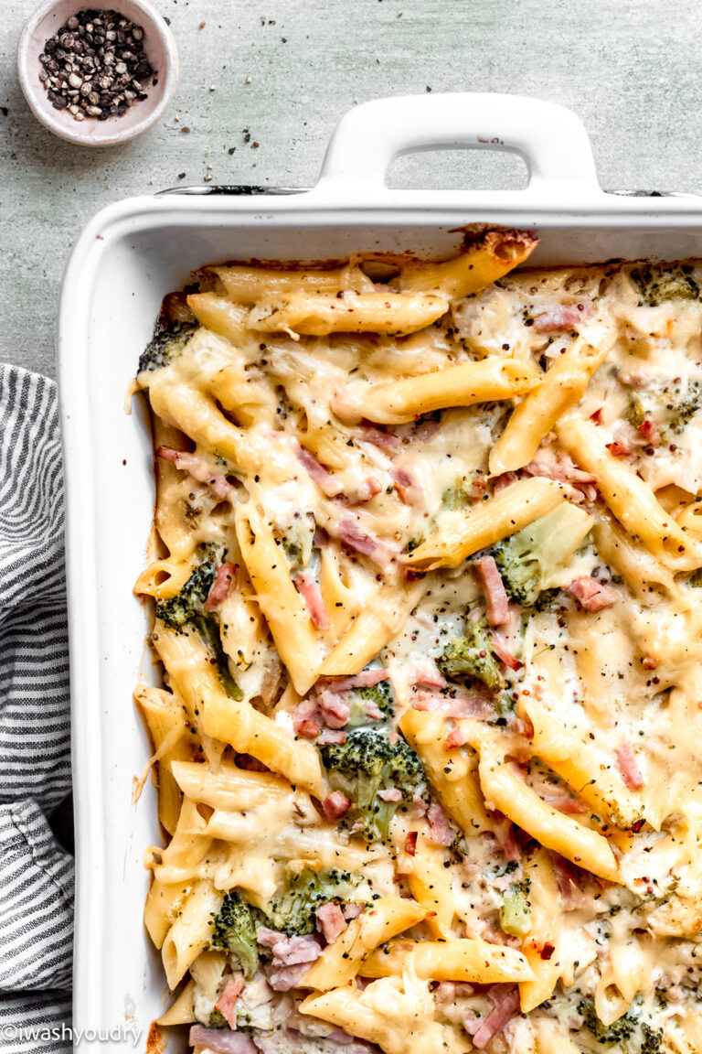 Baked chicken cordon bleu pasta in white pan on marble countertop.
