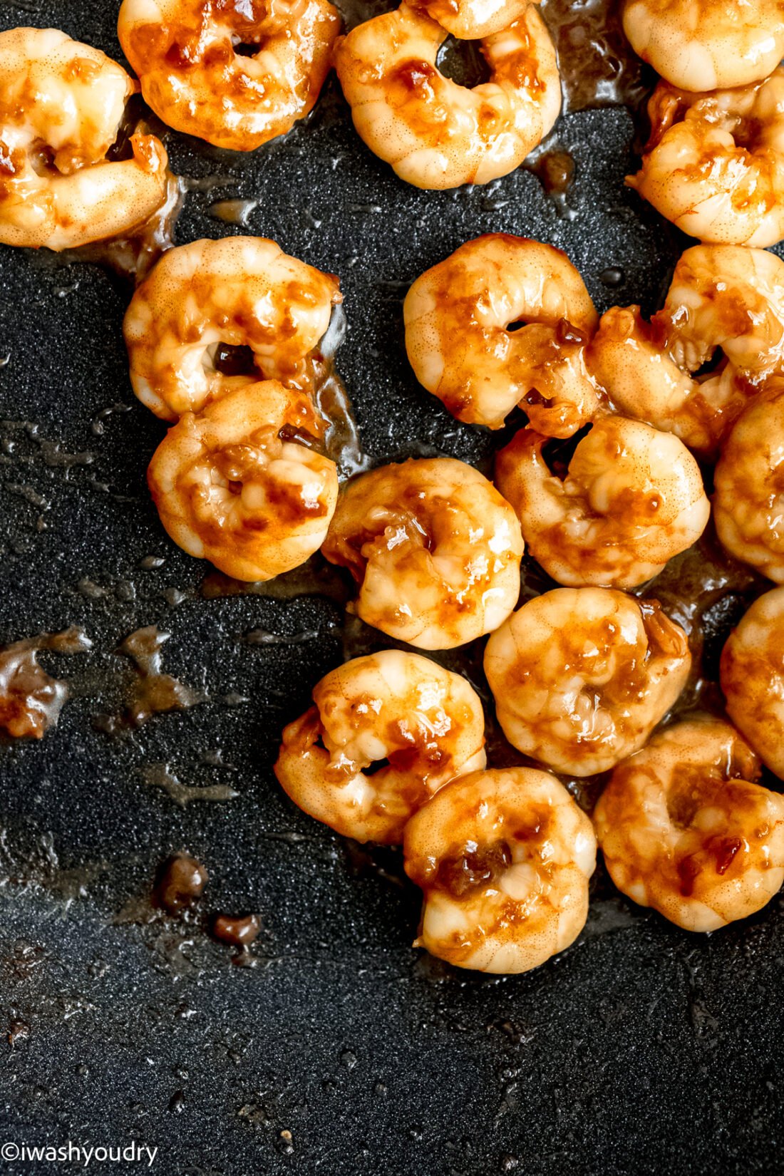 browned shrimp in black pan.