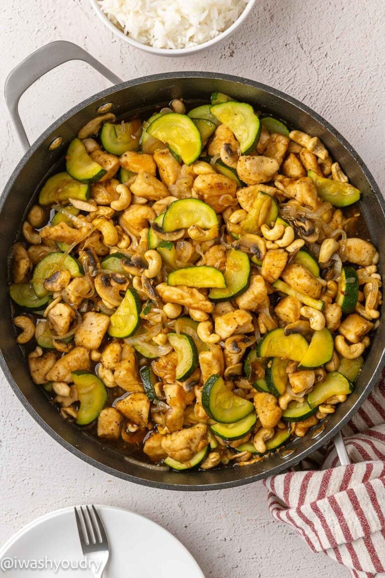 Cooked cashew chicken stir fry in black pan.