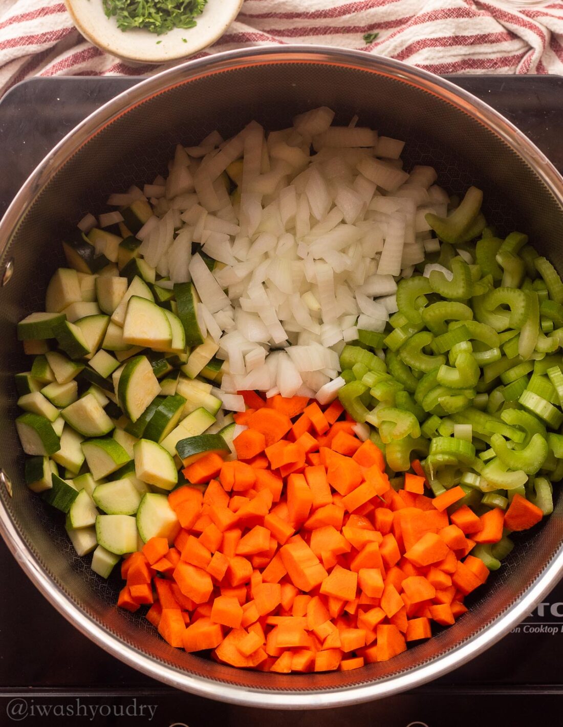 cooking zucchini, carrots, onions and celery in a large pot.