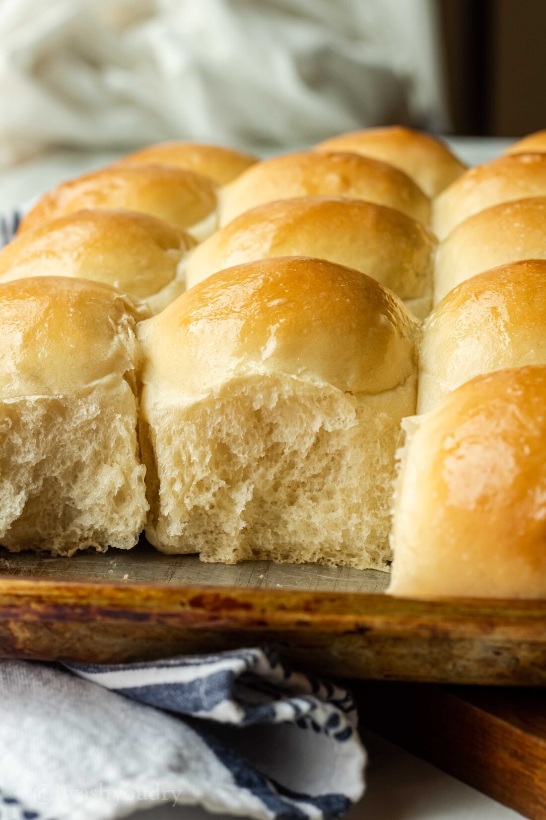 Rolls removed from pan of baked rows of rolls. 