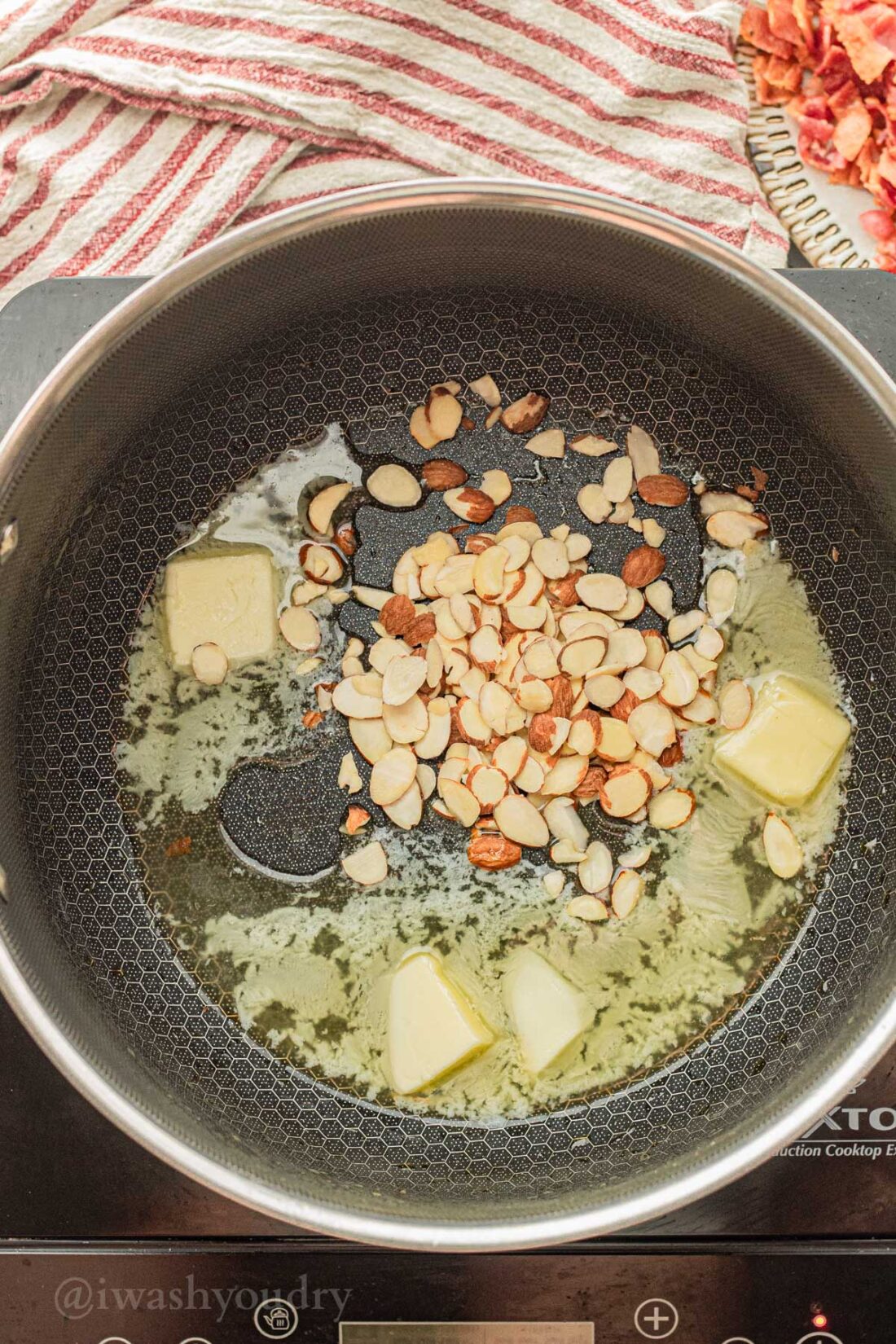 sautéing butter and almonds in black pan.