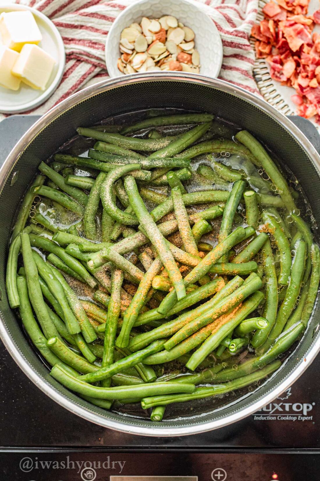 cooking fresh green beans in broth with seasoning.